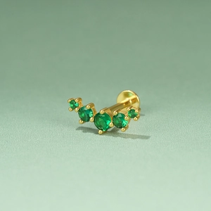 Detailed macro view of S925 silver ear stud with five gradient green emerald stones
