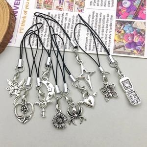 Detailed flat lay of antique silver alloy charms including spider moon and fairy designs