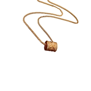 24k gold-plated cylinder necklace with leaf patterns and small cubic zirconia