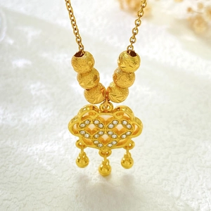 Detail view of a gold lock pendant necklace with micro-paved zircons and gold bead accents