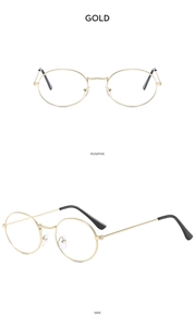 Detail view of gold metal oval sunglasses with black ear tips and slim vintage frame