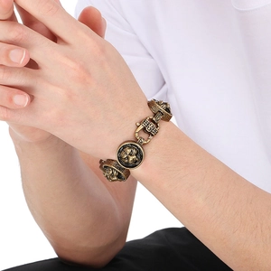 Detail of vintage gold tiger head bracelet showing intricate engravings and spring clasp