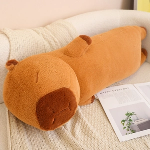 Detailed close-up of a soft plush capybara body pillow on a white sofa and knit blanket