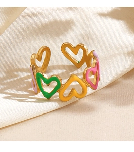 Detailed macro view of colorful enamel heart rings on a premium gold-plated metal base