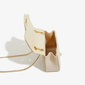 Detail view of open beige quilted crossbody bag with gold chain and interior space