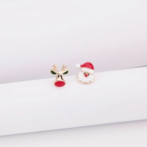 Festive Christmas stud earrings with Santa Claus and reindeer designs on white stand