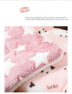 Close-up of thick pink plush pet blanket with white stars and brown bear patterns
