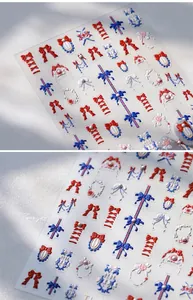 Detailed view of 5D embossed nail stickers featuring red and blue 3D bow and lace patterns