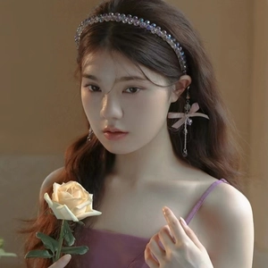 Elegant beaded headband with crystal tassels and butterfly earrings on a fashion model