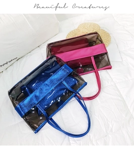 Detail of transparent PVC beach bags in rose red and deep blue with matching inner pouches