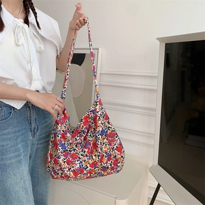 Detailed view of large floral canvas tote bag featuring vibrant red and yellow patterns