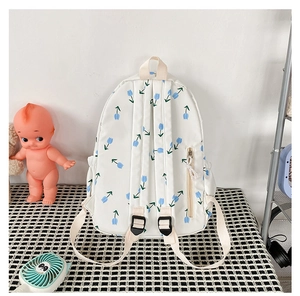 Detail view of the floral canvas backpack back featuring adjustable straps and zipper pocket