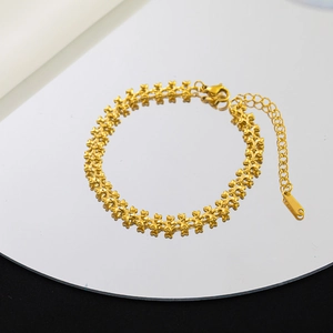 Minimalist gold heart chain necklace with lobster clasp shown on a round mirror surface
