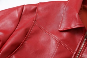 Macro view of bright red PU leather collar and shoulder with white double stitching detail