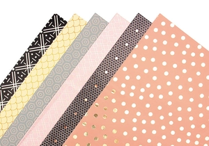 Detail showing assorted geometric patterns and gold foil textures on luxury gift wrap paper