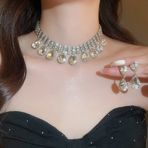 Close-up of sparkling rhinestone water drop fringe necklace and matching earrings set