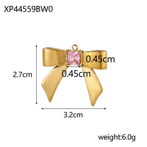 Golden bow pendant with pink stone detail, dimensions 2.7cm by 3.2cm and weight 6.0g