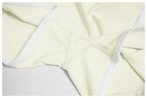 Macro shot of fine triangular reinforced stitching on cream stretch yoga shorts