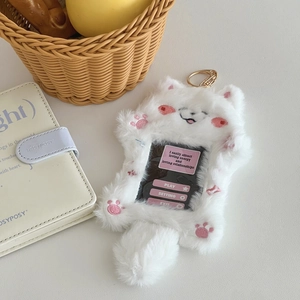 Close-up of plush cat idol card holder with soft white fur and golden metal keychain