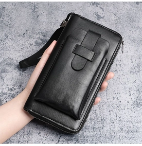 Close-up of black leather long wallet with external phone pocket and metal zipper closure