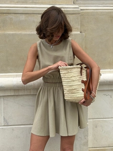 Two-piece cotton linen set featuring sleeveless crewneck top and pleated mini skirt in sage green