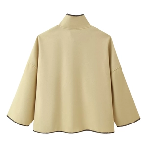Back view of beige wool coat with distinctive black contrast hand-stitched embroidery