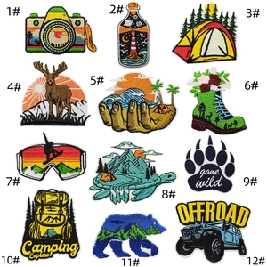 Detailed close-up of 12 distinct outdoor camping and adventure themed embroidered patches
