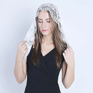 White floral lace bridal mantilla veil featuring intricate embroidery on a model