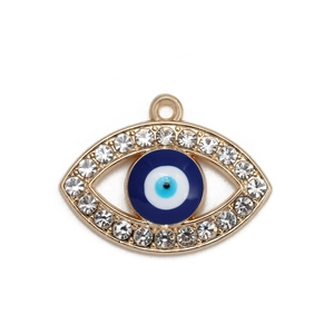 Macro shot of gold Evil Eye pendant with blue concentric circles and sparkling rhinestones