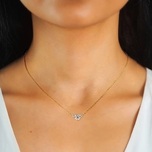 Elegant gold heart necklace with three sparkling moissanite stones on a delicate chain
