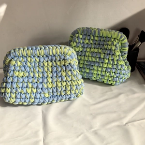 Detail showing the thick cotton knit texture of blue and yellow-green crochet cloud bags