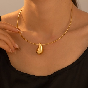 Elegant 18k gold plated teardrop pendant necklace on snake chain worn by a model