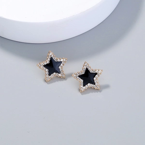 Elegant gold star tassel earrings with black enamel and sparkling zircon accents