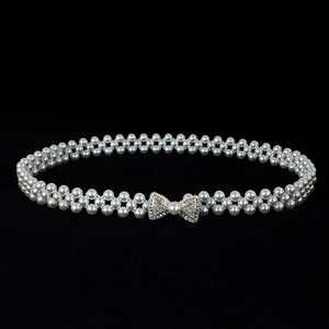Detail of elegant bow-shaped rhinestone buckle and double-row elastic pearl waist chain