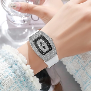 Close-up of a tonneau quartz watch featuring a diamond-set bezel and white silicone strap