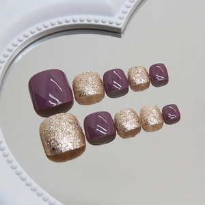 24pcs dark plum purple and gold glitter press-on toenails on a mirror tray display