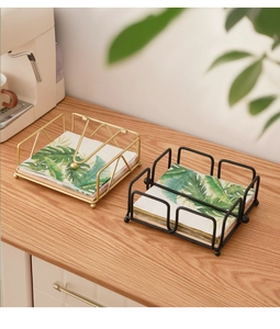 Modern iron wire napkin holder with weighted arm and ball feet in gold and black finish