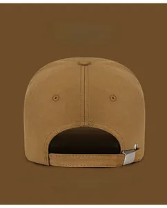 Detail of adjustable metal buckle and twill fabric texture on a brown baseball cap