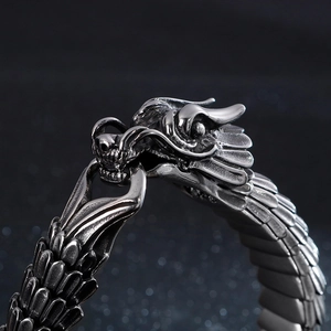 Macro shot of retro stainless steel dragon head with detailed scales and engraved textures
