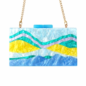 Detail of colorful wavy acrylic evening clutch with premium gold chain strap