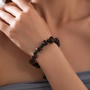 Sugar cube bracelet with coffee beans and green beads on a model's wrist