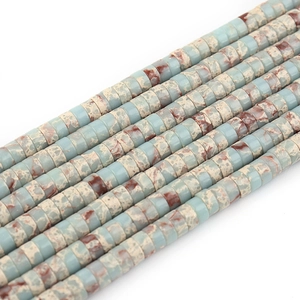 Macro shot of colorful imperial stone flat disc beads with natural blue and brown textures