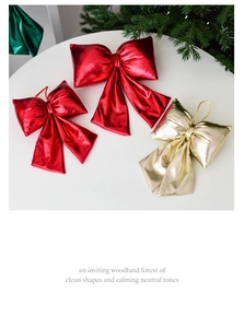 Close-up of red and gold metallic satin Christmas bows on white table for tree decoration