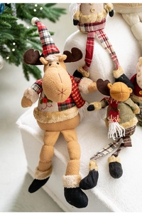 Detailed view of plush Christmas reindeer dolls with knitted hats and plaid scarf decorations