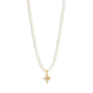 Detailed shot of white baroque pearl necklace with a golden star-shaped cubic zirconia pendant