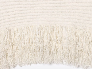 Close-up of white knit fabric texture and fringe tassel details on a mini skirt set