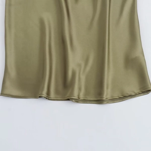 Detailed close-up of the elegant olive green satin midi dress showing smooth hem texture