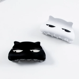Set of creative cat-shaped hair claws in black and white with cute squinting expressions