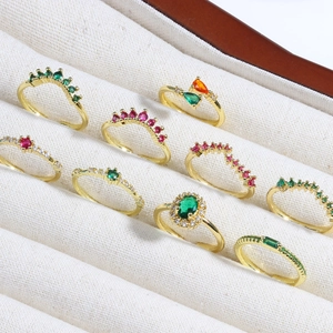Gold open rings set with emerald and ruby zircon stones in velvet jewelry display box