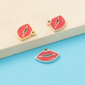 Close-up of red enamel lip pendants in gold and silver steel for DIY jewelry making
